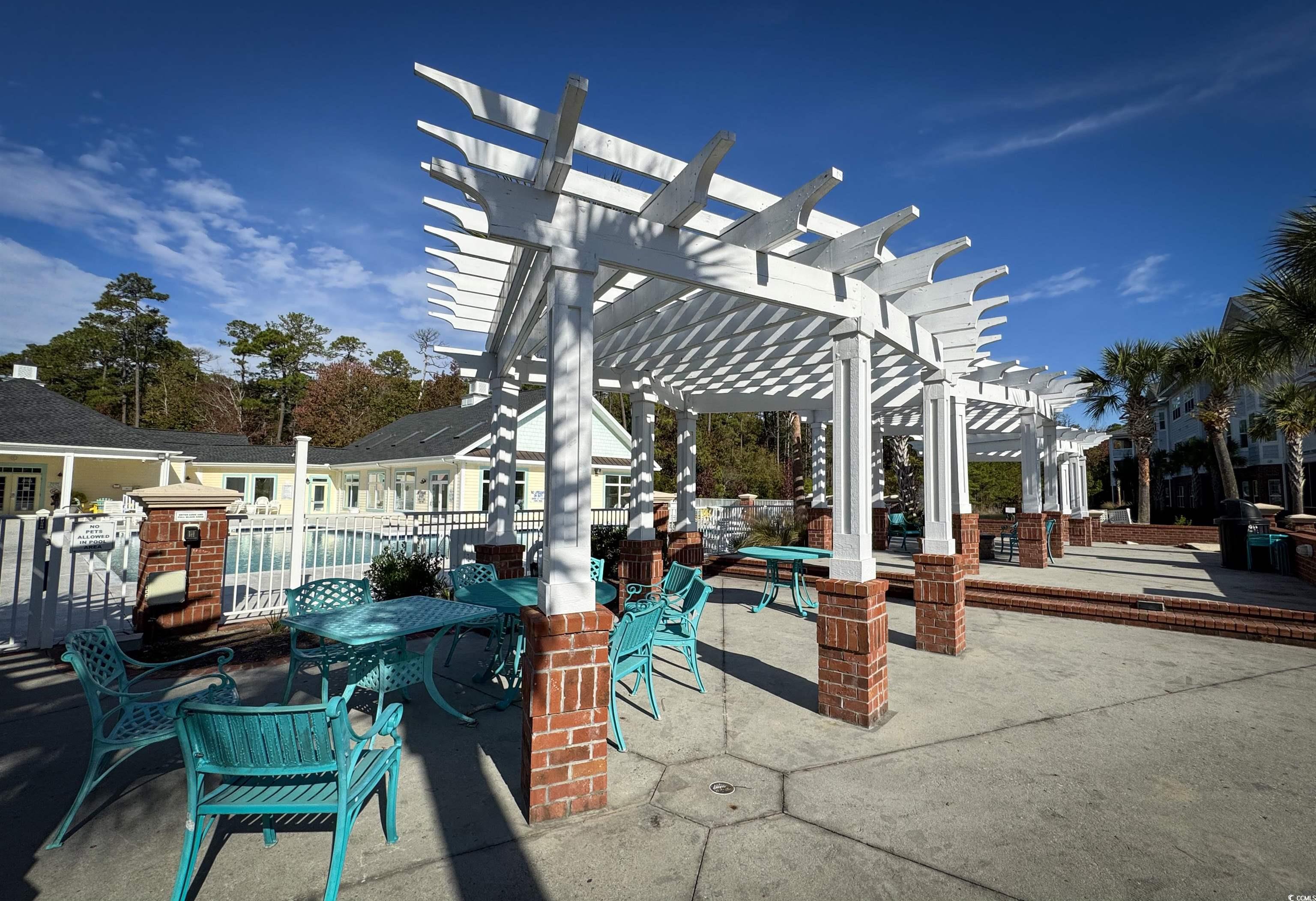 1004 Ray Costin Way, Unit 206 Murrells Inlet, SC 29576 - Photo 26 of 29 View of patio / terrace featuring a pergola for shade while grilling and entertaining.