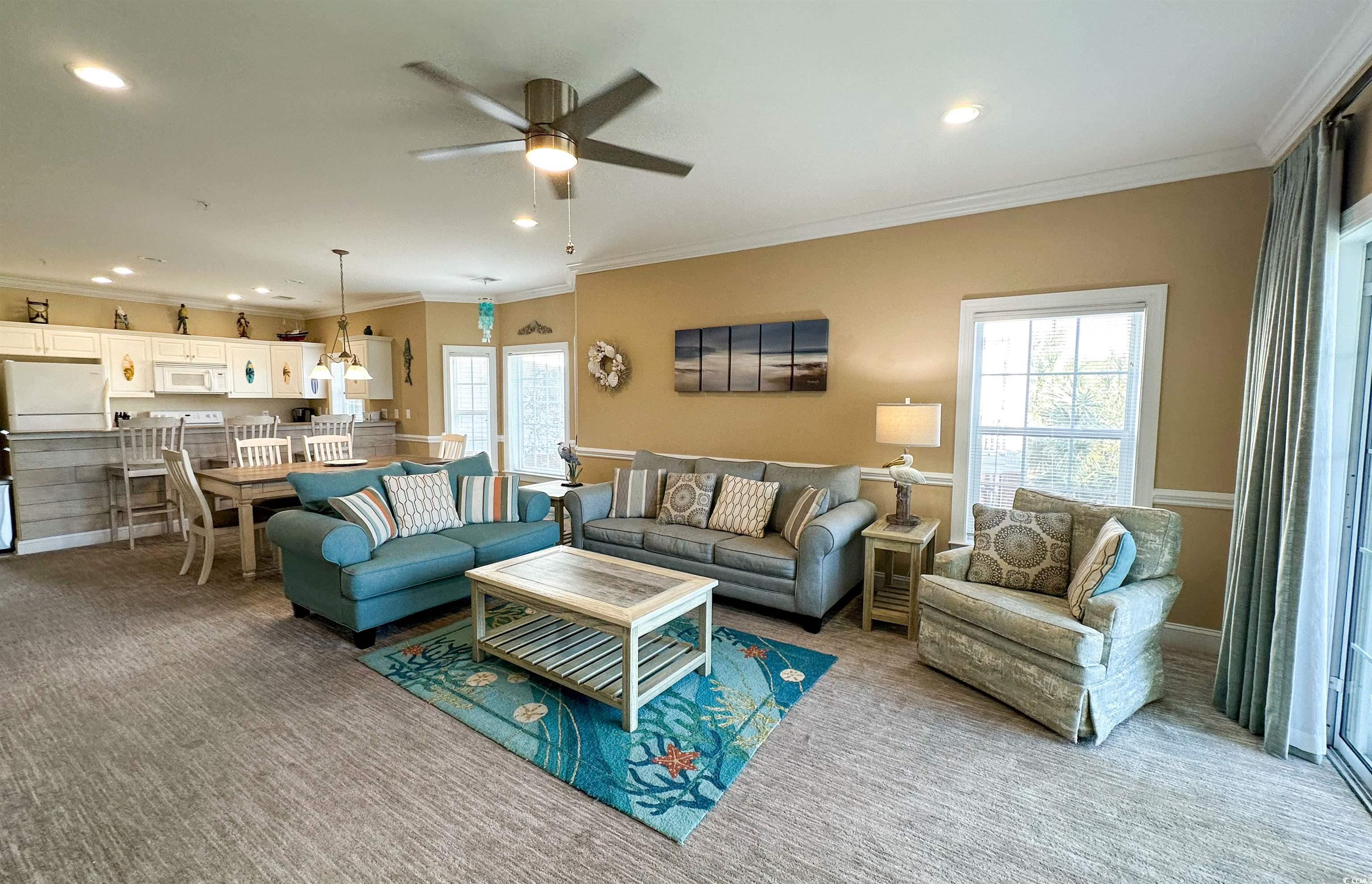 1004 Ray Costin Way, Unit 206 Murrells Inlet, SC 29576 - Photo 4 of 29 Living room with light carpet, ceiling fan, and crown molding