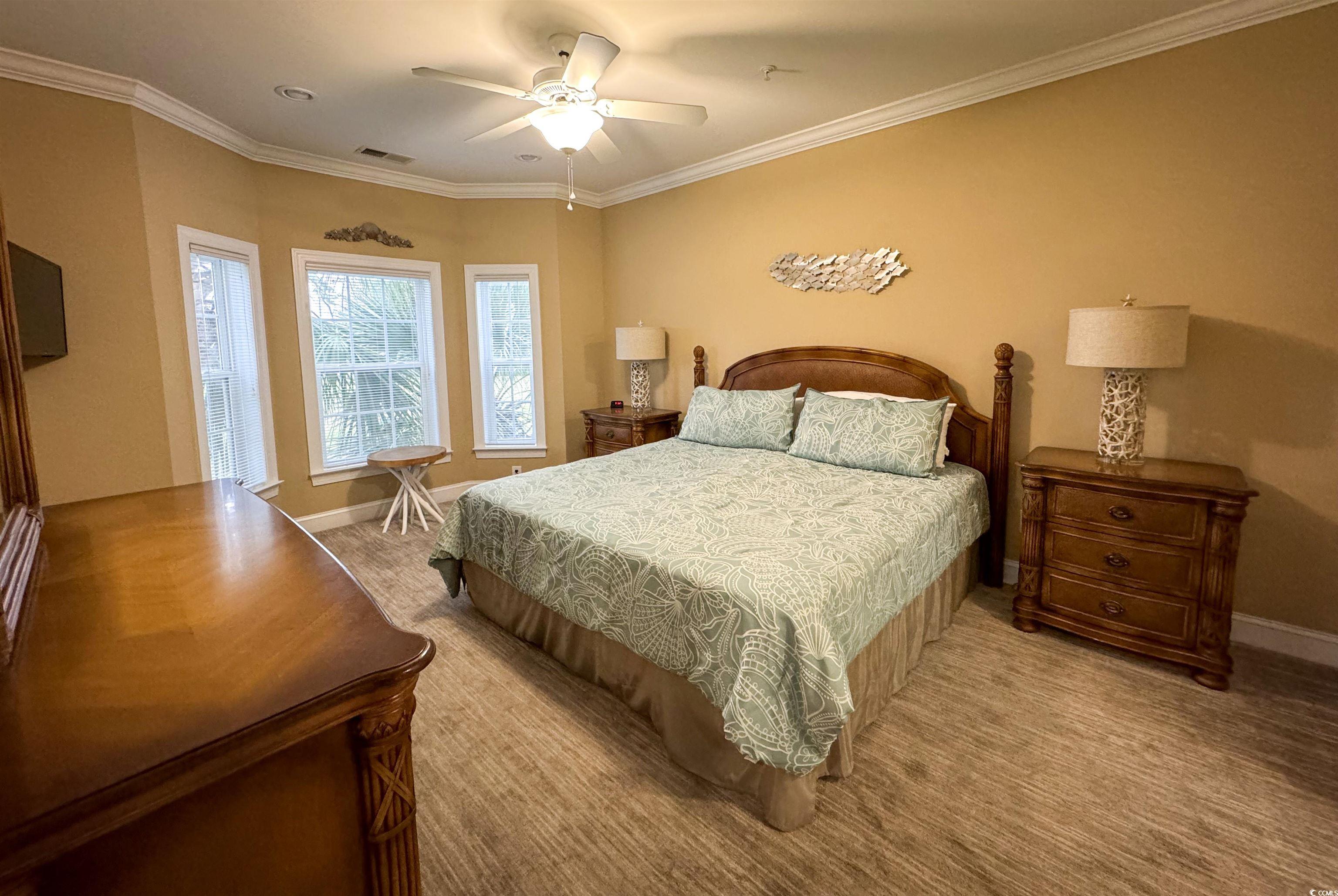 1004 Ray Costin Way, Unit 206 Murrells Inlet, SC 29576 - Photo 10 of 29 Master bedroom with ceiling fan and crown molding