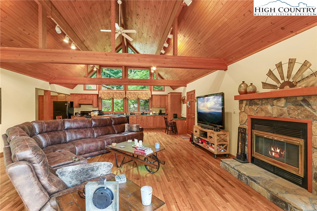 770 Grady Winkler Road Boone, NC 28607 - Photo 11 of 44 a living room with furniture a fireplace and a flat screen tv