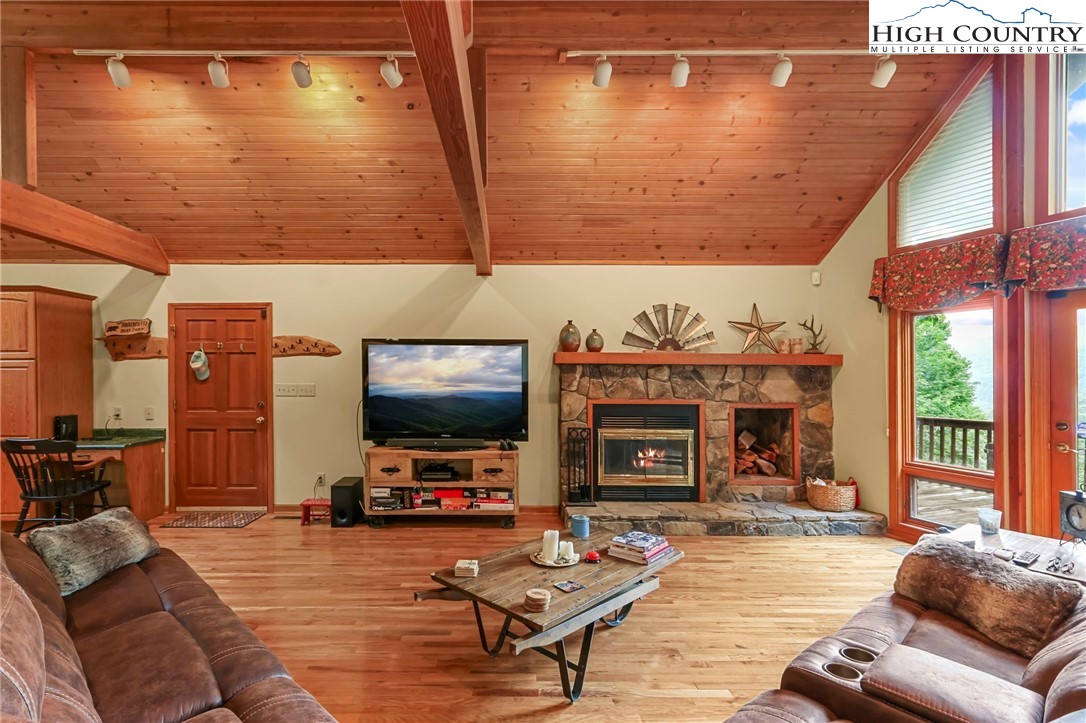 770 Grady Winkler Road Boone, NC 28607 - Photo 12 of 44 a living room with furniture a fireplace and a flat screen tv