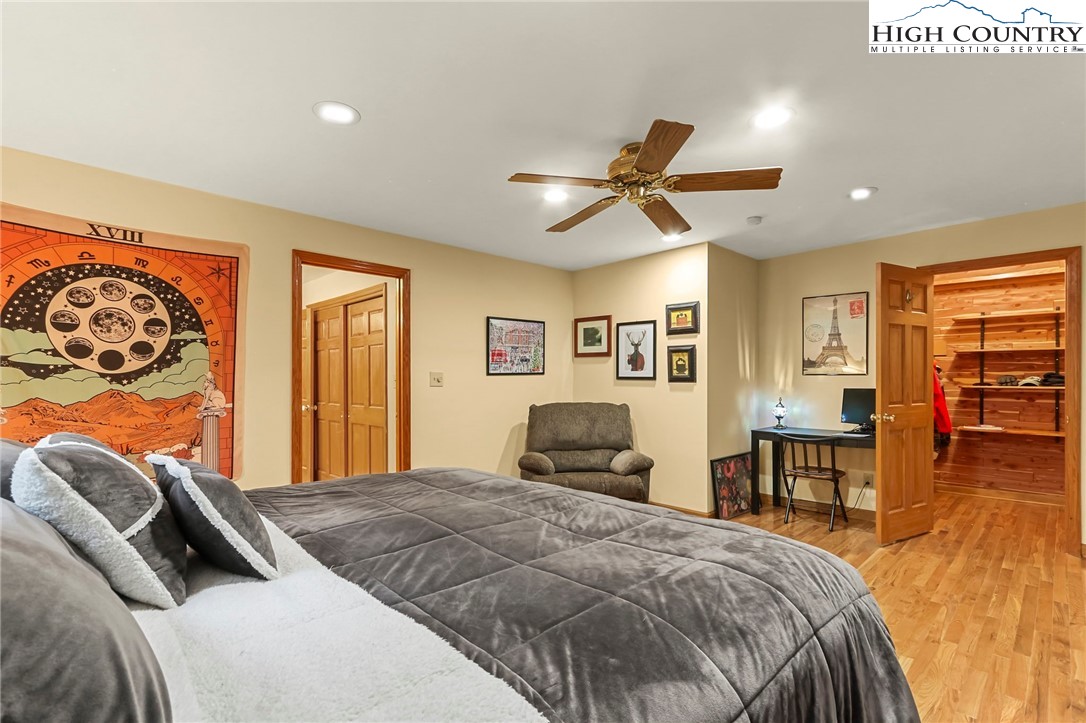 770 Grady Winkler Road Boone, NC 28607 - Photo 14 of 44 a bedroom with a bed and a chandelier
