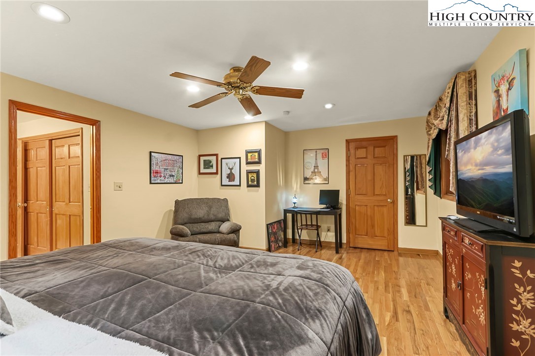 770 Grady Winkler Road Boone, NC 28607 - Photo 15 of 44 a bedroom with a bed and a flat screen tv