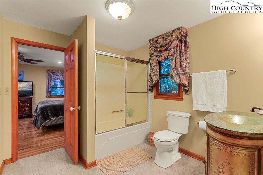 770 Grady Winkler Road Boone, NC 28607 - Photo 17 of 44 a bathroom with a toilet a sink and a mirror