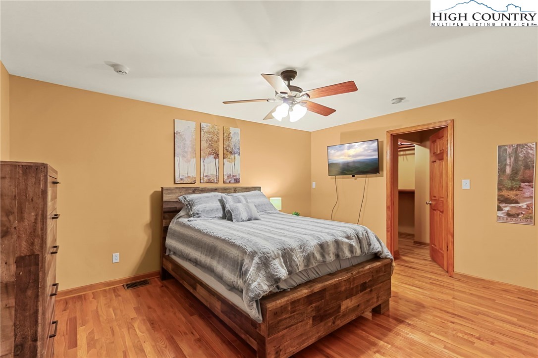770 Grady Winkler Road Boone, NC 28607 - Photo 19 of 44 a bedroom with a bed and a chandelier