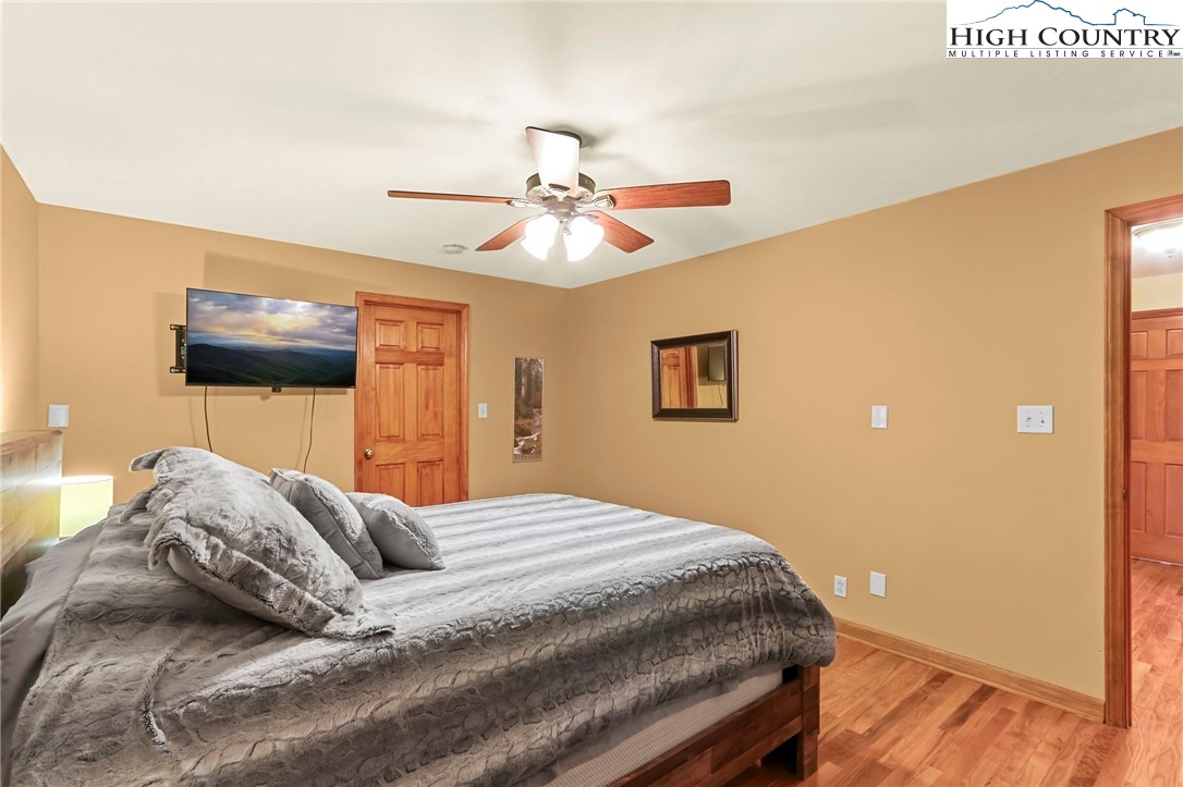770 Grady Winkler Road Boone, NC 28607 - Photo 20 of 44 a bedroom with a bed and a chandelier