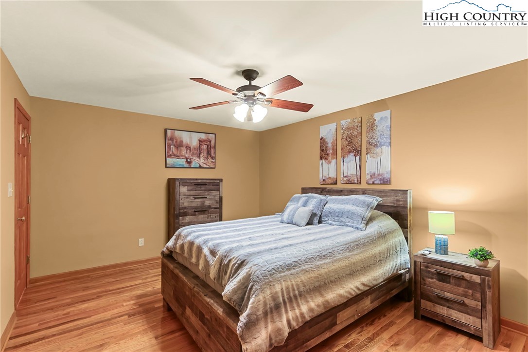 770 Grady Winkler Road Boone, NC 28607 - Photo 21 of 44 a bedroom with a bed and a chandelier