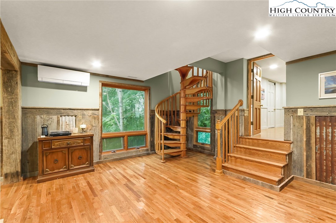 770 Grady Winkler Road Boone, NC 28607 - Photo 22 of 44 wooden floor in an empty room with a fireplace and windows