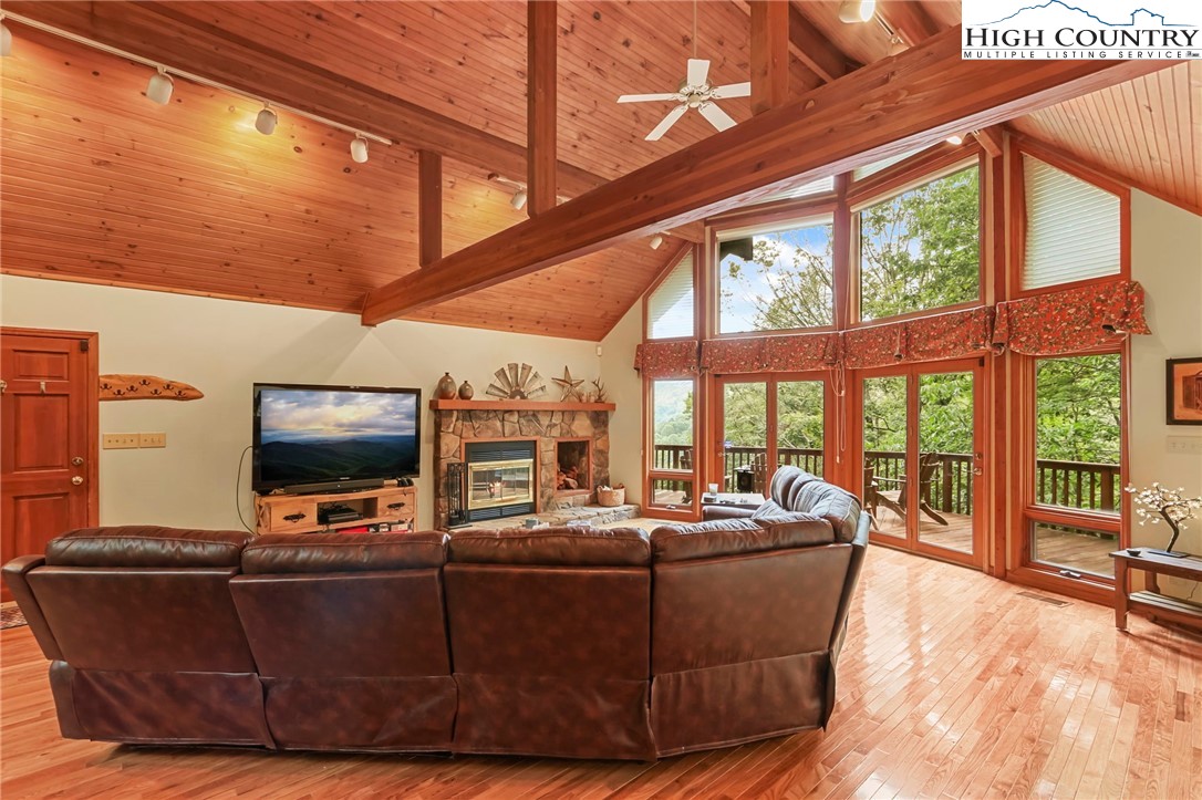 770 Grady Winkler Road Boone, NC 28607 - Photo 7 of 44 a living room with couches a flat screen tv and large windows