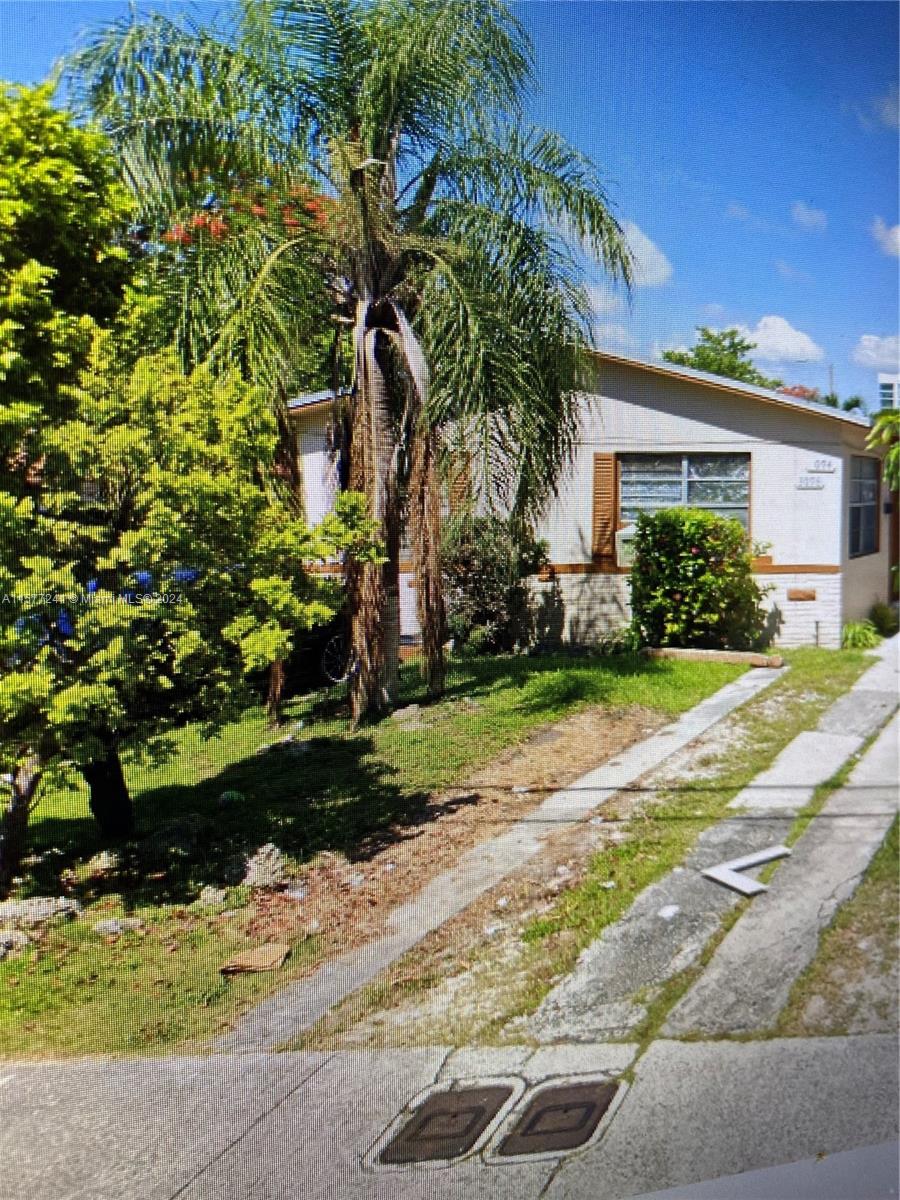 3082 Carter Street Miami, FL 33133 - Photo 1 of 3 a front view of a house with a yard and a garage