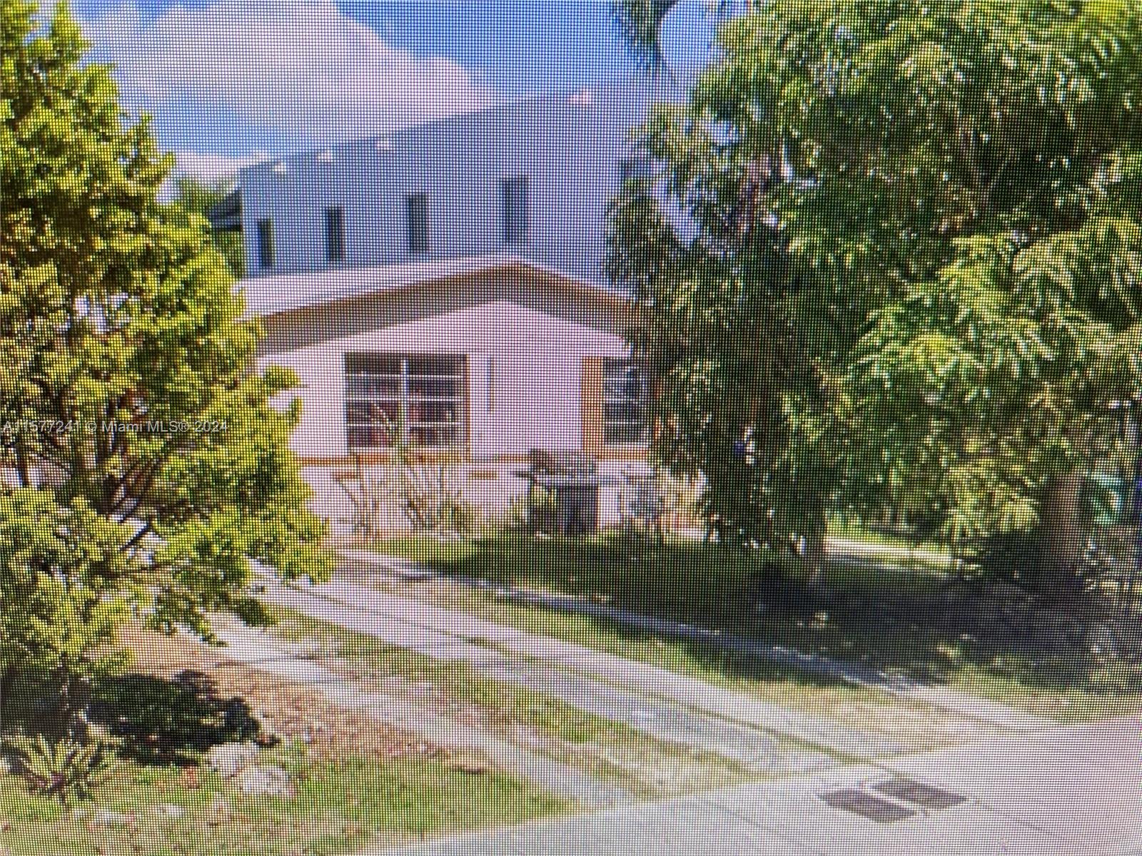 3082 Carter Street Miami, FL 33133 - Photo 2 of 3 a front view of a house with a yard