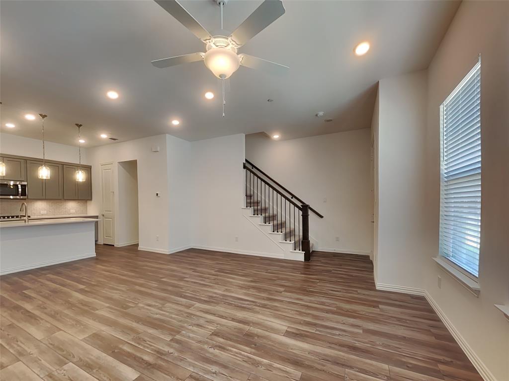 1069 Keene Rdg Drive Allen, TX 75013 - Photo 3 of 10 an empty room with wooden floor and staircase