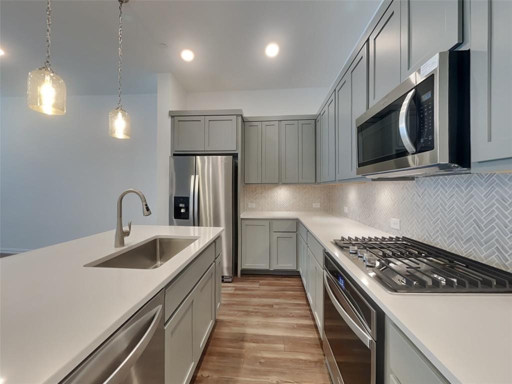 1069 Keene Rdg Drive Allen, TX 75013 - Photo 4 of 10 a kitchen with stainless steel appliances granite countertop a sink a stove and a refrigerator