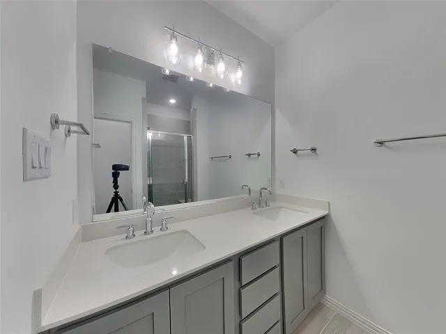 a bathroom with a sink vanity and a mirror