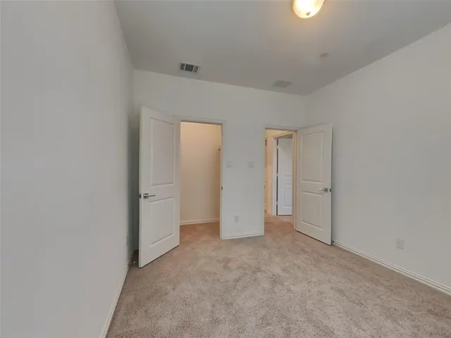 a view of an empty room and closet area