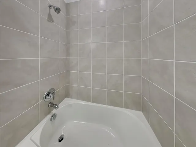 a white bath tub and a shower