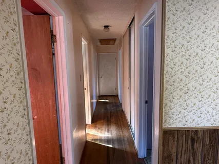 a view of a livingroom and a hallway