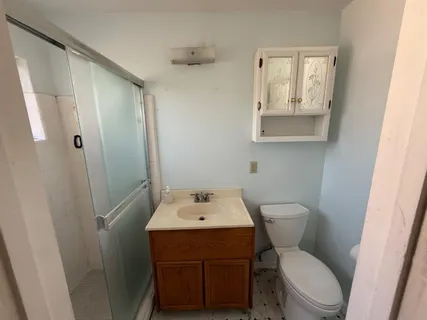 a bathroom with a toilet sink and mirror
