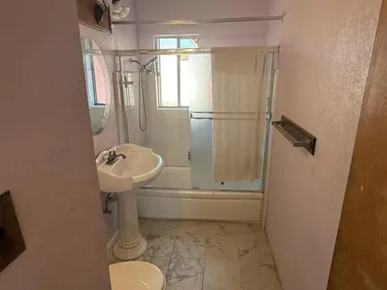 a bathroom with a sink toilet and shower