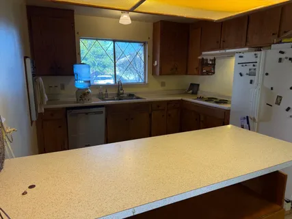 a kitchen with a wooden floor and cabinets