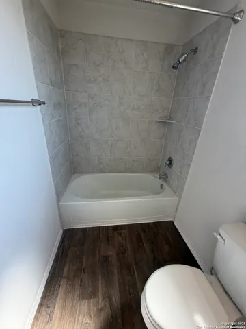 a bathroom with a bathtub and a toilet