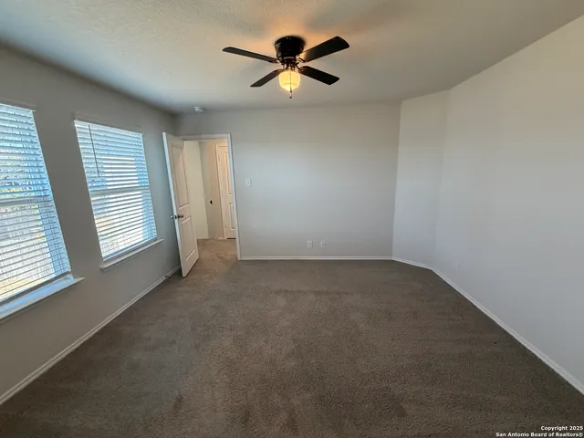 an empty room with closet and windows