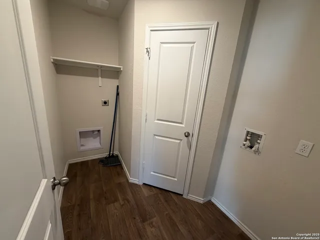 a view of a room with wooden floor