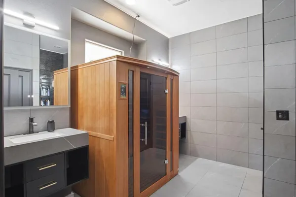 a bathroom with a shower and a sink