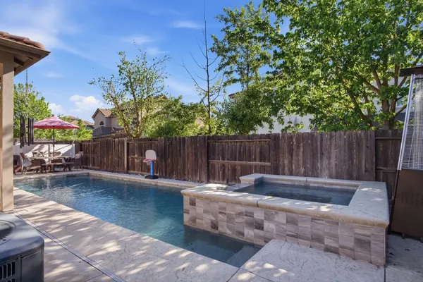 a backyard of a house with table and chairs