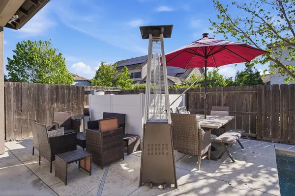 a patio with a patio table and chairs