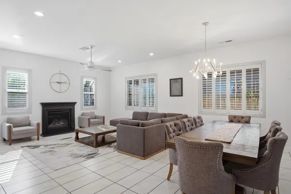 a living room with furniture a fireplace and a large window