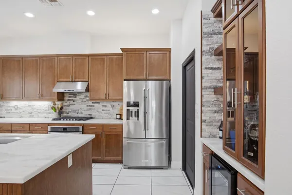 a kitchen with a refrigerator and a sink