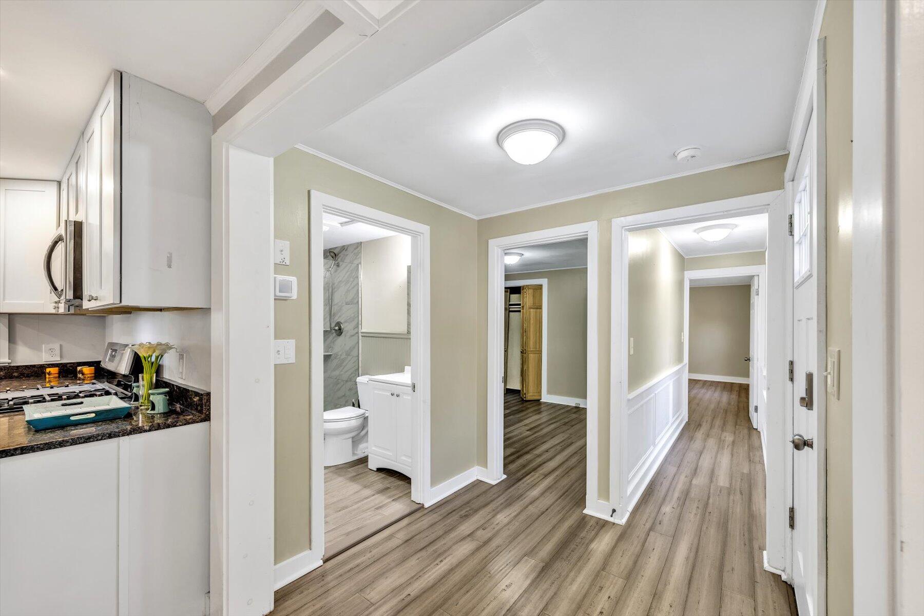 576 Strawberry Hill Road Centerville, MA 02632 - Photo 15 of 38 a view of a hallway with wooden floor and a bathroom