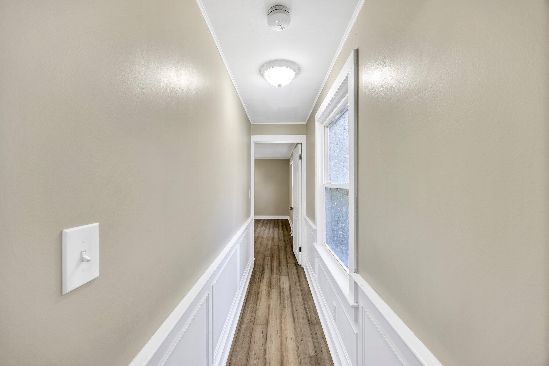576 Strawberry Hill Road Centerville, MA 02632 - Photo 16 of 38 a view of a hallway with wooden floor