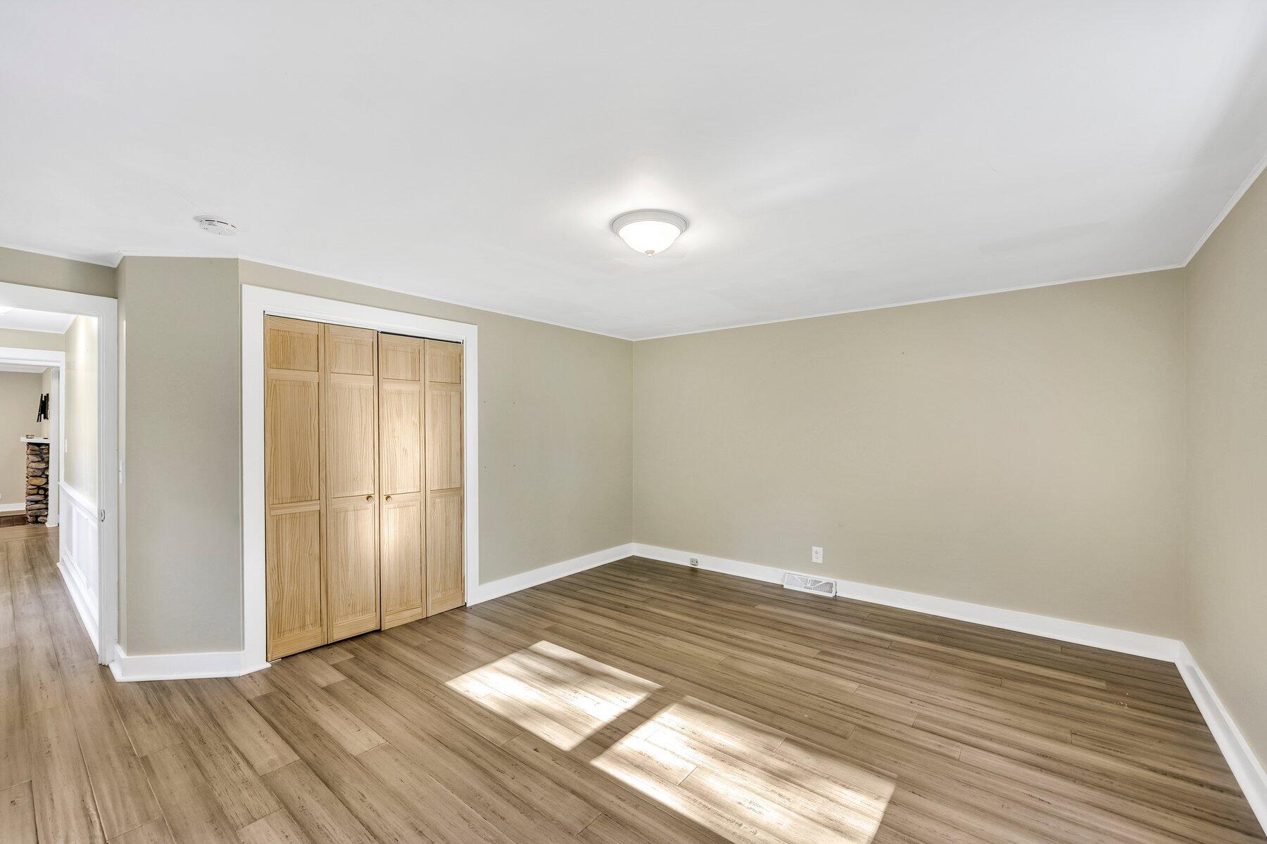 576 Strawberry Hill Road Centerville, MA 02632 - Photo 21 of 38 a view of empty room with wooden floor and fan