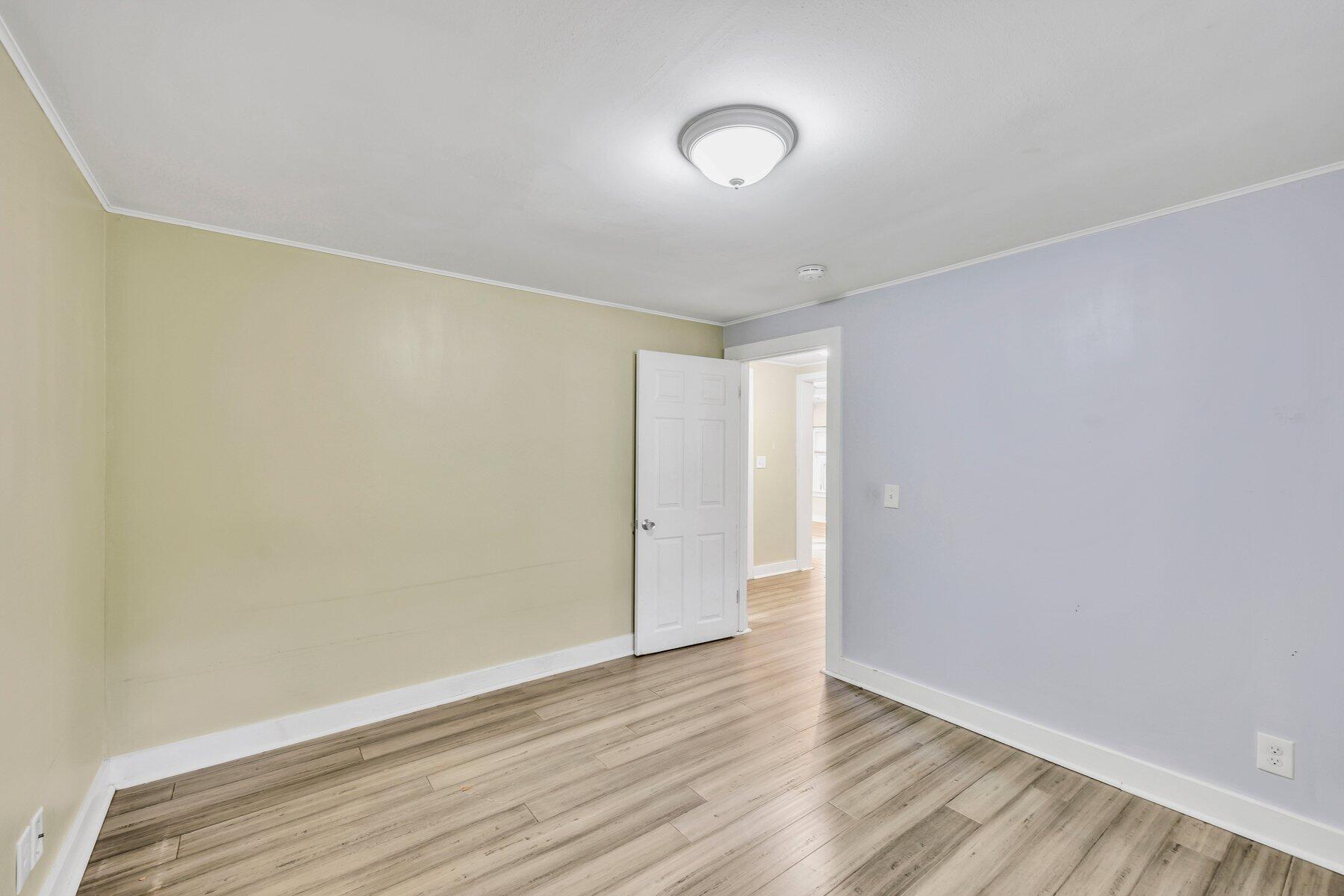 576 Strawberry Hill Road Centerville, MA 02632 - Photo 25 of 38 an empty room with wooden floor and windows