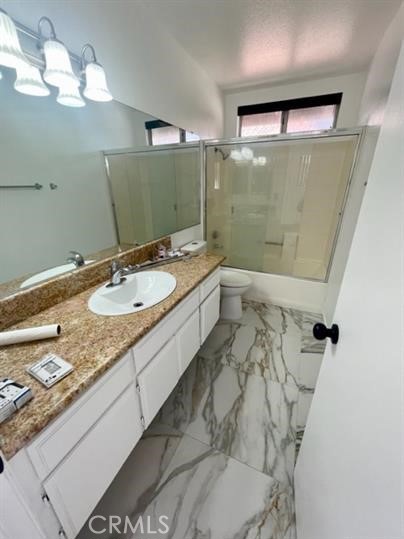 22710 Brompton Street Moreno Valley, CA 92553 - Photo 21 of 23 a bathroom with a granite countertop sink a toilet and shower