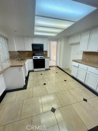 22710 Brompton Street Moreno Valley, CA 92553 - Photo 6 of 23 a kitchen with granite countertop a sink and a stove