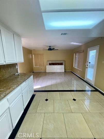 22710 Brompton Street Moreno Valley, CA 92553 - Photo 7 of 23 a kitchen with a sink a stove cabinets and a counter top space