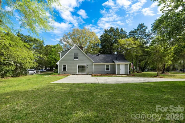 a front view of house with yard and green space
