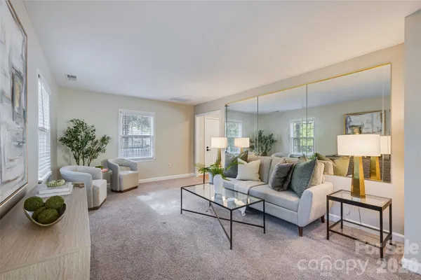 a living room with furniture and a potted plant