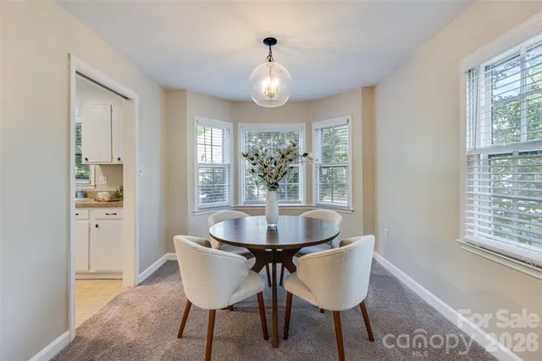 a dining room with furniture and window