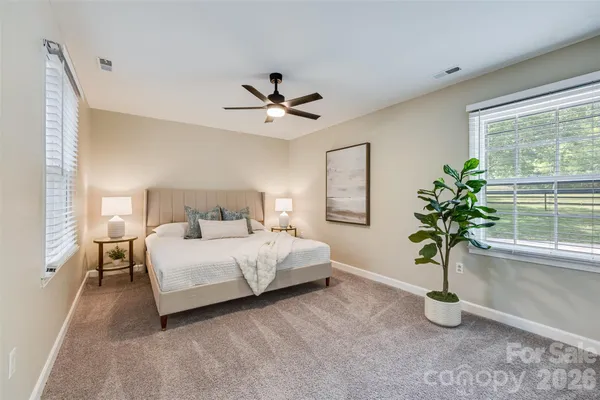 a bedroom with a bed and a potted plant