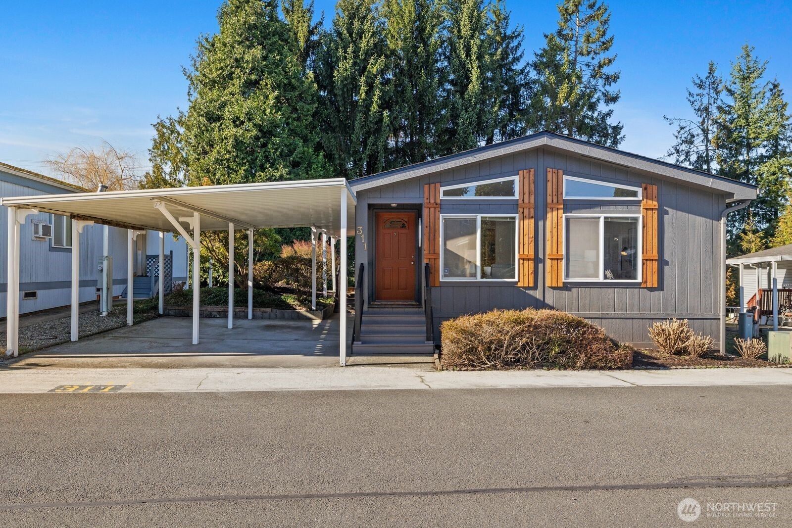 23825 15th Avenue Southeast, Unit 311 Bothell, WA 98021 - Photo 1 of 24 a front view of a house with a garden