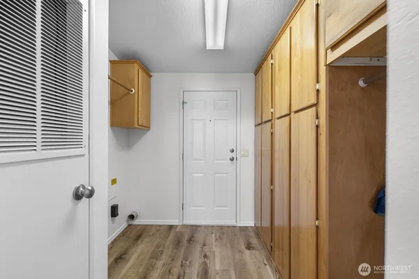 a view of a livingroom with wooden floor and a bathroom