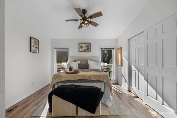 a bed room with a bed and a ceiling fan