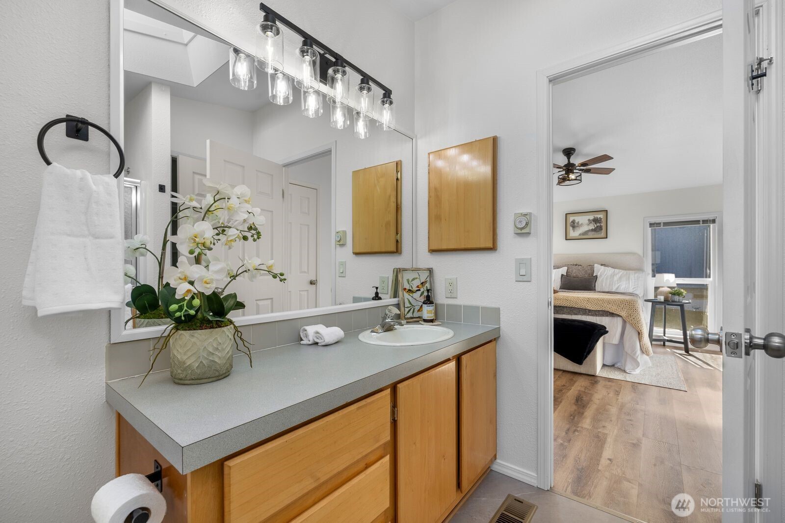 23825 15th Avenue Southeast, Unit 311 Bothell, WA 98021 - Photo 18 of 24 a bathroom with a sink a mirror and vanity