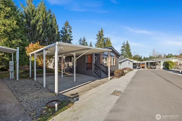 a view of a house with backyard porch and sitting area