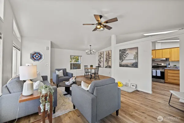 a living room with furniture and wooden floor