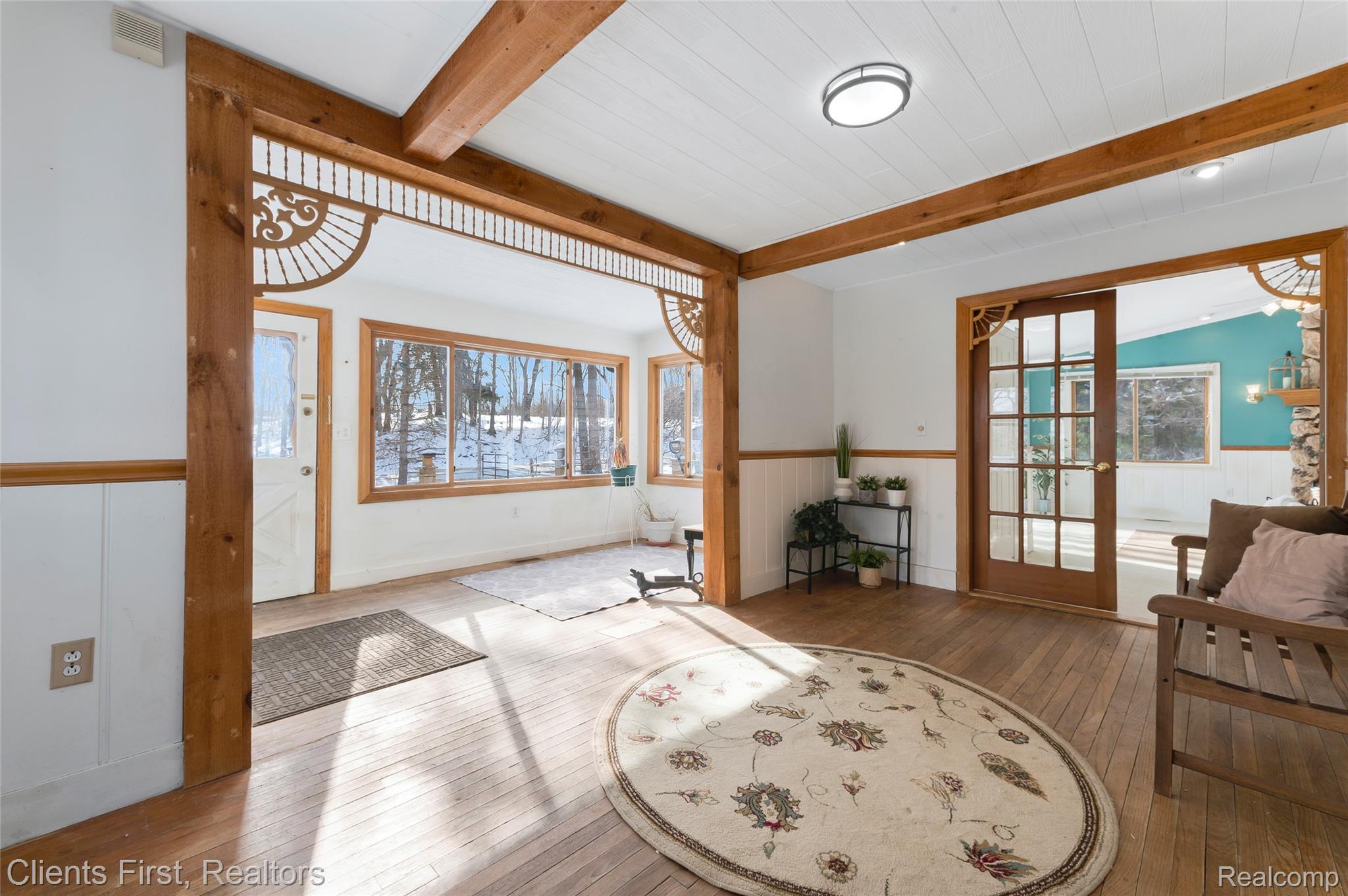 9985 Ford Road Ypsilanti, MI 48198 - Photo 16 of 58 Foyer with wood flooring, beam ceiling, plenty of natural light, and a wainscoted wall